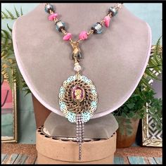 Bj Adorned Crown Assemblage Statement Necklace Original Design Necklace Assembled Using A Vintage Glass Intaglio Cameo Mounted On A Gold Tone And Teal Filigree Background. I’ve Assembled The Chain With A Vintage Natural Patina Brass Hand Charm Holding The Pendant And Hung From Wire Wrapped Pink Howlite Stone Beads And Faceted Glass Beads. Measures 21” Long With An Asymmetrical Side Closing Hook And Eye Clasp Pendant Measures 2” Assemblage Jewelry Is Made Using Pre-Loved Pieces Of Jewelry, Toys, Pink Bohemian Necklace For Party, Elegant Pink Necklaces For Festivals, Pink Handmade Beaded Necklaces, Pink Bohemian Beaded Necklace For Party, Elegant Pink Beaded Necklace For Festival, Stone Bead Necklace, Vintage Assemblage Jewelry, Crown Vintage, Howlite Stone