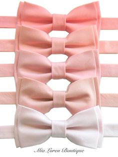 four pink and white bow ties are lined up on top of each other in rows