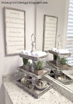 three trays with plants in them sitting on a bathroom counter top next to two mirrors