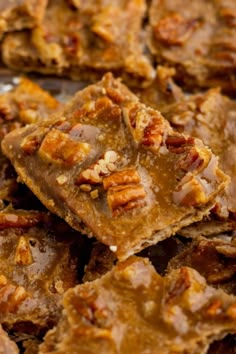 pecan bars are stacked on top of each other with walnuts in the middle