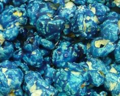 blue and yellow popcorn kernels sitting on top of each other