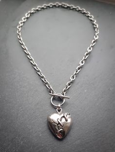 Stunning broken/ mended heart pendant necklace with toggle bar clasp! Made of 100% stainless Steel so is water resistant and won't tarnish or discolour.  Heart pendant measures 31x26mm Available in various lengths  (necklace shown in photographs measures 17 inches) Please don't hesitate to contact me with any queries or suggestions 😊  Comes gift wrapped 💜 Metal Heart Necklace With Lobster Clasp, Metal Necklaces With Heart Pendant And Toggle Clasp, Metal Toggle Necklace With Lobster Clasp Pendant, Metal Pendant Toggle Necklace With Lobster Clasp, Metal Heart Toggle Necklace With Heart Charm, Heart-shaped Metal Toggle Necklace With Adjustable Chain, Metal Toggle Necklace With Heart Charm, Metal Heart Pendant Necklace With Toggle Clasp, Metal Toggle Necklace With Heart Pendant As Gift