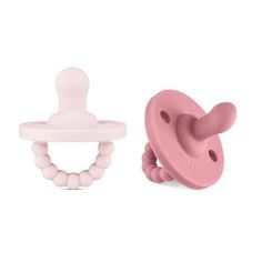 two pink pacifiers with teeth attached to them