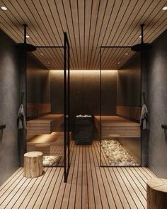 an indoor sauna with wooden floors and benches