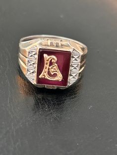 Delayed Shipping-we are away from our shop and won't be able to mail until July 8 Larry, Liam Or Linda would love this ring. Sterling and 10K gold signet/monogram set on faux red ruby backing. Lots of detail will make this a special ring for that special someone. SEE PHOTOS Ring is marked Sterling/10K and a SA incised signature  Ring size 10 1/2 - 11 Ask questions if unsure Condition is good, this is VINTAGE, used and might show wear Check our shop to see more Vintage items www.etsy.com/shop/missenpieces Classic Red Signet Ring For Formal Occasions, Heirloom Red Gold Signet Ring, Classic Red Engraved Jewelry, Antique Red Signet Ring In 14k Gold, Antique Red 14k Gold Signet Ring, Red Engraved Signet Ring For Formal Occasion, Formal Red Engraved Signet Ring, Classic Red Signet Ring Stamped 14k, Classic 14k Gold Red Signet Ring