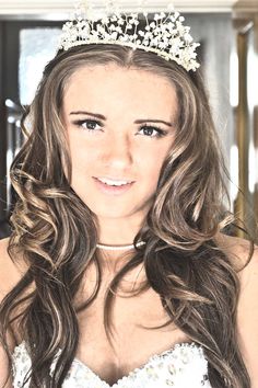 a beautiful young woman wearing a tiara