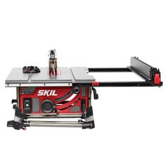 the skil table sawing machine is on top of a stand with tools attached to it