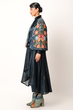 Midnight blue jacket with cape sleeves, abstract pattern patch work panels, multi color floral thread, applique and zari embroidery. Paired with flared anarkali with high-low hem and straight pant.
Components: 3
Pattern: Embroidered and Printed
Type Of Work: Applique, Thread and Zari Work
Neckline: Jacket: Band Collar
Sleeve Type: Jacket: Cape Sleeves
Fabric: Chanderi, Velvet, Cotton Slub
Color: Blue
Other Details: 
Panelled jacket
Length:
Cape: 23.5 inches
Anarkali Front: 38 inches
Anarkali Bac Traditional Embroidered Anarkali Set With Cape Sleeves, Designer Embroidered Kurta With Cape Sleeves, Traditional Dupatta With Cape Sleeves And Pallu, Traditional Anarkali Set With Cape Sleeves And Dupatta, Traditional Anarkali Set With Cape Sleeves For Navratri, Traditional Embroidered Kurta With Cape Sleeves, Blue Chanderi Long Sleeve Bandhgala, Blue Long Sleeve Chanderi Bandhgala, Traditional Kurta With Sheer Dupatta And Cape Sleeves