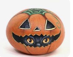 an orange painted pumpkin with a black cat's face on the front and side