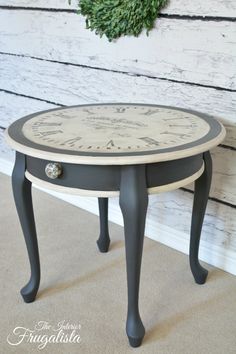 a small black and white table with a clock on it