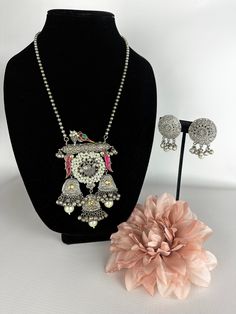 This unique tribal jewelry piece is perfect for a vibrant and fun look and is made in oxidized silver finish plating with matching earrings to go with the necklace. The Design is made of birds and Pink Stones for a splash of color on this modern sabyasachi piece along with beautiful matching earrings to go perfectly with the necklace! A vibrant and modern look for any event! This lightweight and elegant necklace is perfect for any bridesmaid, bride, sangeet or any occasion or event as a gift for Silver Peacock Design Jewelry Sets For Festivals, Silver Jewelry Sets With Oxidized Finish Pendant, Silver Metal Necklace With Peacock Design, Silver Jewelry With Peacock Design For Festivals, Silver Peacock Design Jewelry For Party, Silver Necklace With Peacock Design, Multicolor Oxidized Temple Jewelry Sets, Multicolor Oxidized Jewelry Sets For Wedding, Multicolor Oxidized Finish Jewelry Sets For Wedding