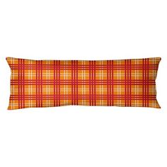 an orange and yellow plaid pillow on a white background