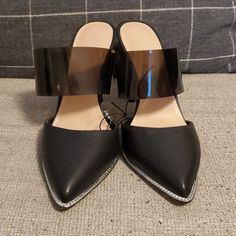 Black Slip On Heels. Plastic Strap And Metal Accents Inthe Front. Brand New, Never Worn - No Box. Trendy Mules With Contrasting Heel Counter For Party, Trendy Mules With Contrasting Heel For Party, Black Mules With Contrasting Heel Counter For Evening, Black Closed Toe Mules For Party, Evening Black Mules With Contrasting Heel Counter, Black Open Heel Mules For Party, Black Open Heel Party Mules, Trendy Black Mules For Party, Party Black Open Heel Mules