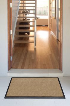 an open door leading to a living room with stairs