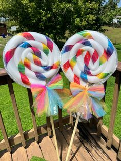 two lollipops sitting on top of each other in front of a wooden fence