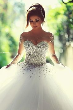 a woman in a white wedding dress is posing for the camera with her hands on her hips