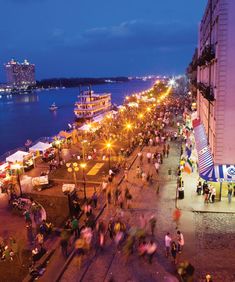 many people are walking on the beach at night