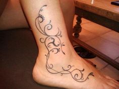 a woman with a tattoo on her foot