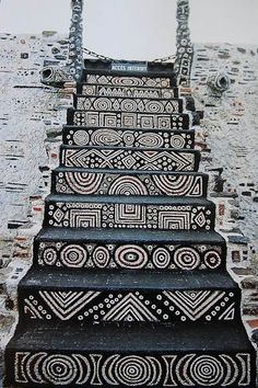 an artistic stair case painted with black and white designs