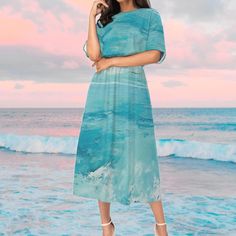 The skirt features a beautiful waves design inspired by the ocean, creating a unique and eye-catching look. The flowing lines and curves mimic the movement of the water, adding a sense of fluidity and grace to the garment. The combination of different shades of blue and white adds depth and dimension to the pattern, making it a versatile piece that can be paired with a variety of tops and accessories. Whether for a casual day out or a special occasion, this ocean waves pattern skirt is sure to m Flowy Blue Skirt For The Beach, Blue Beach Maxi Skirt, Blue Maxi Skirt For Beach, Blue Maxi Skirt For The Beach, Blue Mermaid Dress For The Beach, Blue Mermaid Dress For Beach, Bohemian Turquoise Skirt For Summer, Beachy Blue Short Sleeve Dress, Turquoise Bohemian Summer Skirt