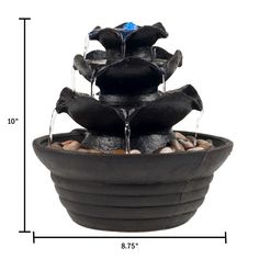 a water fountain is shown with rocks in it