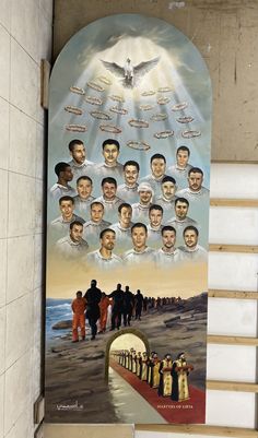 a large poster on the side of a building with many people standing in front of it