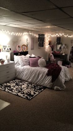 a bed room with a neatly made bed and lights