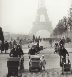 an old black and white photo of people in front of the eiffel tower