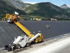 a large truck is parked in front of a mountain