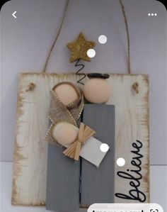 a wooden sign with two shoes and a star hanging from it's side on a wall