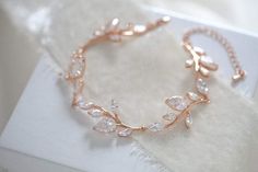 This delicate Rose gold cubic zirconia cuff bracelet for bride is inspired by nature with it's lovely leaf design. Perfect for a bridal look or any special occasion.- Crafted with Swarovski Pure Brilliance components.- All clear stones- Rhodium, yellow gold or rose gold finish- Bracelet measures 6.5 inches and extends Gold Bridesmaid Bracelet, Bracelet For Bride, Gold Infinity Bracelet, Bridal Backdrop Necklace, Bridal Bracelet Pearl, Rose Gold Wedding Jewelry, Pearl Bracelet Wedding, Backdrops Necklace, Crystal Bridal Earrings