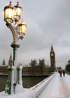 the big ben clock tower towering over the city of london covered in snow and ice