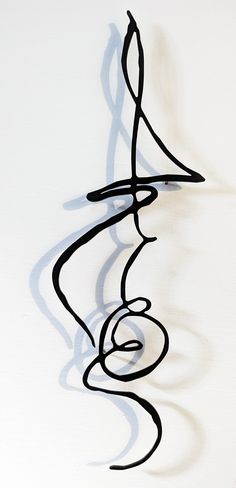 a sculpture made out of black lines on a white wall with a clock in the background