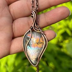 A rainbow labradorite cabochon with a strong silver sheen, wrapped in solid antiqued copper wires. Available as a solo pendant, or with a matching solid antiqued copper chain. CHAIN LENGTH: If you don't see your desired chain length in the options above, feel free to add it in the "note to seller" section at checkout.  (example: "15 inch chain please")  Message me if you prefer a chain over 32 inches.  PACKAGING: All pieces are re-polished before they are shipped, and arrive in a simple gift box, ready to be gifted! (Or kept forever!)  JEWELRY CARE: Copper will naturally darken and antique over time, however it is very easy to polish with a jewelry polishing cloth, steel wool, or you can even polish copper jewelry with the ketchup in your fridge! If you need any help with caring for and ma Handmade Iridescent Labradorite Necklace, Simple Wire Wrapped Pendant, Wire Wrapped Bead Pendant, Wired Pendants, Wire Wrapped Cabochon, Wire Wrapped Crystal Pendant, Wire Wrap Cabochon, Wire Wrapped Stone Jewelry, Wire Wrap Jewelry Designs