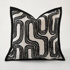 a black and white pillow with wavy lines on it