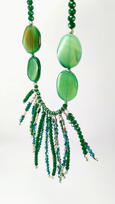 One of a kind long green statement necklace handcrafted with rondel and bicone crystals, silver plated metal beads, green agates and leather. The toggle clasp is stainless steel and it's made with stringing steel cable. It's perfect to highlight your outfit, basic or sophisticated. ❤GIFT WRAPPING: Each product is well packed in a gift bag and box too. ❤IMPORTANT TO KNOW: This piece is one of a kind, that it means, that isn't another piece like that. This is what I love to do: unique pieces for e Handmade Green Crystal Long Necklace, Green Beaded Long Crystal Necklace, Long Green Beaded Crystal Necklace, Elegant Green Beaded Long Crystal Necklace, Green Long Beaded Necklaces With Faceted Beads, Green Beaded Long Necklace With Faceted Beads, Green Long Beaded Necklace With Faceted Beads, Green Long Necklace With Faceted Beads, Green Gemstone Party Beads