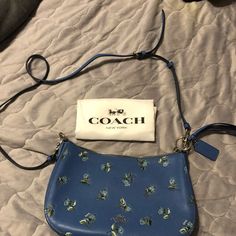 Coach 55373 Slate Blue Floral Print Leather Sutton Crossbody Purse 11"W X 7-1/2"H X 2-3/4"D (Width Is Measured Across The Bottom Of Handbag) Silhouette Is Based Off 5'9" Model 6-1/2"L Handles; 22-1/2"L Strap Zip Closure Silver-Tone Hardware; Varies By Color 1 Interior Zip Pocket Style #: 55373 Leather The Last Photo Is A Stock Photo Coach Crossbody Purse, Skechers Bobs, Brown Leather Crossbody Bag, Grey Bag, Coach Crossbody Bag, Black Leather Crossbody Bag, Coach Leather, Printed Leather, Leather Satchel