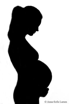 a pregnant woman silhouetted against a white background