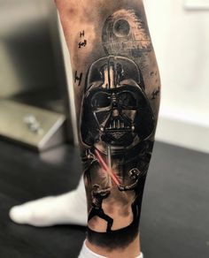 a man's leg with a star wars tattoo on it and a darth vader