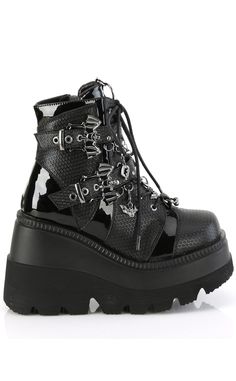 Shake it vampire style with the SHAKER-66 ankle boots! These baddies feature contrasting patent deets and fishnet-look panels, bat buckled straps, a horseshoe piercing, an O ring on the tongue and removable charms on the straps. Slip in and out in a snap with an inner zip and adjustable lace ups. Perfect for bringing your coven to the club! The Shaker series features a 4 1/2 inch platform wedge. Material: 100% vegan PU. US women's sizing-refer to size chart for more info. Punk Patent Leather Platform Boots, Punk Style Platform Boots In Patent Leather, Gothic Platform Ankle Boots With Metal Feet, Gothic Ankle Platform Boots With Metal Feet, Horseshoe Rings, Demonia Shoes, Horseshoe Ring, Pleaser Shoes, Black Platform Boots