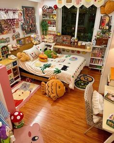 a bedroom with lots of toys and decorations on the floor, including a large bed