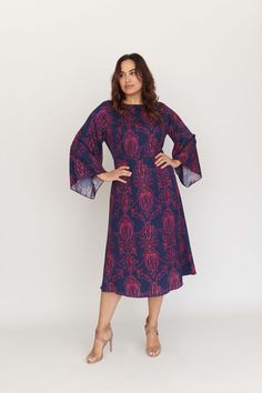 The Lucrezia Bell Sleeve Dress is as diverse as it is chic and works as well before 9 as it does after 5. Take a look at the flattering hourglass fit that truly nips the waist, and the forgiving bell sleeves that waterfall from the shoulders. If you prefer a figure-skimming look, Lucrezia has you covered. The enchanting print in shades of blueberry and blush on our silk twill call to mind sultry nights and delightful days. Let the compliments commence. Product info: 100% Silk Twill. Our model is Chic Dresses With Cape Sleeves For Fall, Formal Midi Dress With Bell Sleeves For Fall, Formal Fall Midi Dress With Bell Sleeves, Spring Midi Dress With Cape Sleeves For Cocktail, Elegant Cocktail Dress With Bell Sleeves, Fitted Flutter Sleeve Dresses For Fall, Elegant Dresses With Unlined Sleeves For Work, Elegant Workwear Dresses With Unlined Sleeves, Party Dresses With Pleated Bell Sleeves