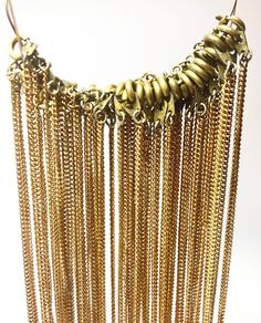 "Description: Gold Tone Vintage Fine Necklaces, Textured Cable Link Chains, finished with round brass clasps (spring ring) Measurements: 16\" long, chain width measures about 1/16th inch Quantity in Lot: 34 necklaces   This listing is for a lot of 34 delicate, gold-tone necklace chains that feature round brass clasps for closure. These supplies are are a bit tarnished, giving them a rustic and truly  Vintage look==and may show some signs of tarnishing but clean up easily. Costume Jewelry Finding Antique Gold Brass Chain Jewelry, Round Chain Necklace With Adjustable Chain, Brass Dangle Chain Necklaces, Bronze Brass Chain Jewelry, Bronze Brass Jewelry With Chain, Brass Chain Necklace With Lobster Clasp, Long Brass Chain Necklace, Gold Bohemian Chain Link Jewelry, Bohemian Gold Chain Link Jewelry