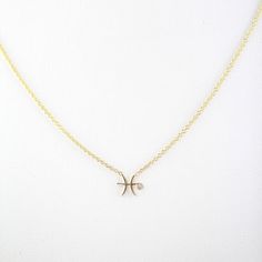 a gold necklace with an x on it