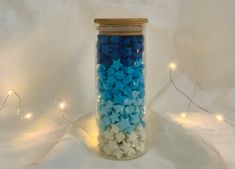 a jar filled with blue and white confetti