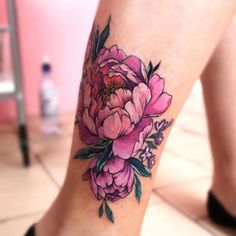 a woman's leg with a flower tattoo on it