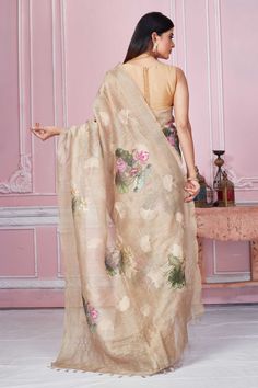 Elegant beige floral print Banarasi saree is a perfect drape for light festive occasions. It comes with a blouse piece. Disclaimer: The shown stitched blouse on the model is for display purpose only. The saree comes with a matching blouse piece and finished with fall and piko. Festive Beige Pre-draped Saree, Beige Pre-draped Saree With Zari Work, Beige Pre-draped Saree, Beige Pre-draped Saree For Festive Occasion, Cream Tissue Silk Saree, Diwali Beige Traditional Drape Blouse Piece, Semi-stitched Beige Saree With Zari Work, Beige Semi-stitched Saree With Zari Work, Beige Zari Work Saree For Diwali