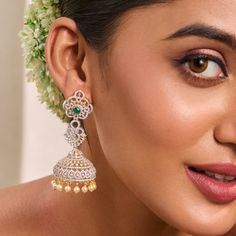 Description: Gorgeous and elegantly simple, these elegant CZ jhumka earrings add radiance to any outfit. Featuring an array of high-quality CZ stones set in 925 silvers in floral design, they shine beautifully. Style with a pastel-hued dress or an elegant silk saree to make the green center stone stand out. Product Information: Metal: 925 Silver with Gold & White Gold Plating Length: 7 cm Stones: High Grade CZ Stones Findings: Push back Elegant American Diamond Jhumkas For Wedding, Elegant Jhumkas With Intricate Design In Cubic Zirconia, Wedding Jhumkas With Intricate Cubic Zirconia Design, Festive Silver Jhumkas With Elegant Design, Elegant Cubic Zirconia Jhumkas With Intricate Design, Wedding Cubic Zirconia Jhumkas With Intricate Design, Elegant Jhumkas With Intricate Design For Reception, Cubic Zirconia Chandbali Jhumkas For Wedding, Wedding Chandbali Jhumkas With Cubic Zirconia