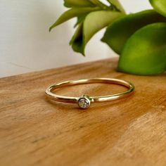 This Tiny White Sapphire Ring is made from solid 14k gold.  It's a dainty ring that looks great stacked with as many as you would like.  It's a simple ring that also looks wonderful on it's own as a small promise ring, wedding ring, or even an engagement ring. -Just over 1mm thick -Listing for ONE ring -14K Solid Gold Band -Solid Gold Setting -2mm AA White Sapphire Each ring is completely handcrafted just for you or your special someone and then polished to a high shine. If you would like a different stone other than what is listed, contact me and I would be happy to get you a price quote. Please see shipping for current fabrication times. Similar Items: https://www.etsy.com/shop/RitoOriginals?section_id=12545643&ref=shopsection_leftnav_3 *Each piece of jewelry is completely handcrafted an Tiny Rings, White Sapphire Ring, Solid Gold Band, Simple Ring, Simple Engagement Rings, Solid Gold Ring, Ring Simple, Price Quote, Stone Engagement Rings