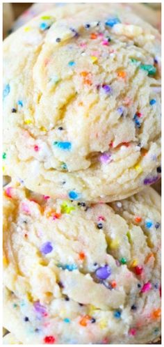 three cookies with sprinkles stacked on top of each other in a pile